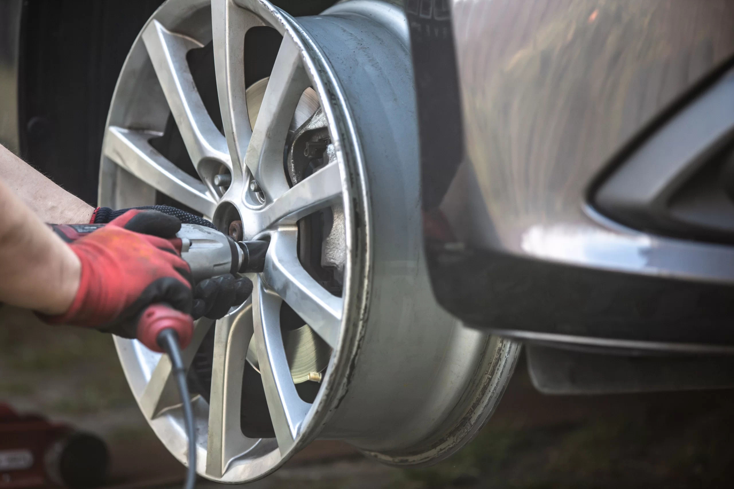 car-maintenance-service-man-changing-wheels-in-a-2023-11-27-04-54-52-utc